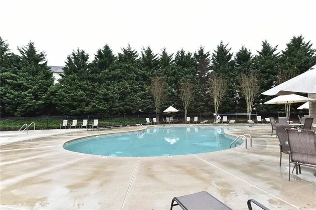 a view of a swimming pool and lounge chairs
