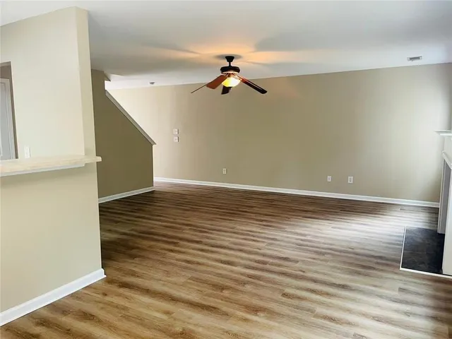 a view of a room with wooden floor