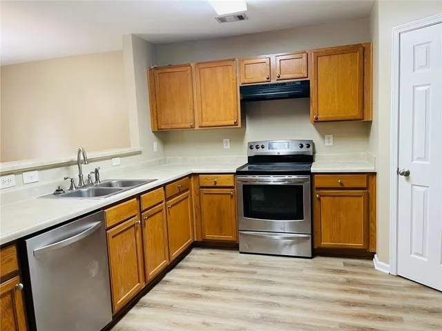 a kitchen with granite countertop a stove and a sink