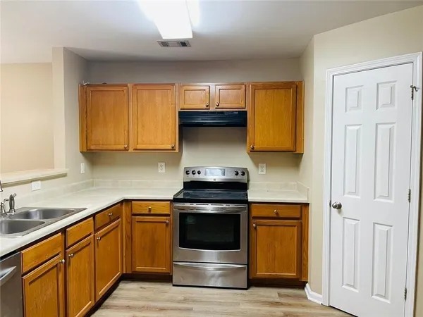 a kitchen with a stove and a sink