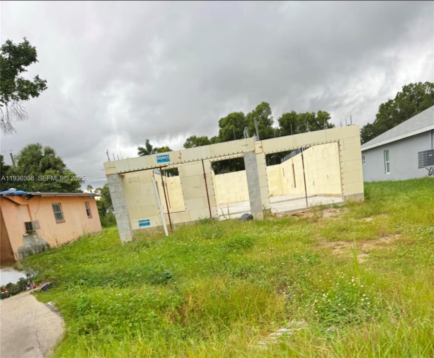 3208 Jeffcott Street Fort Myers, FL 33916 - Photo 7 of 7 a view of a white house with a big yard and large trees