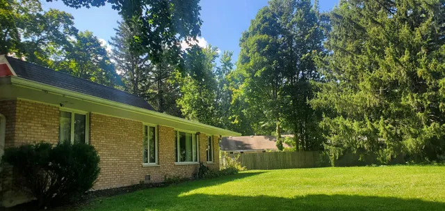 a view of a backyard with large trees