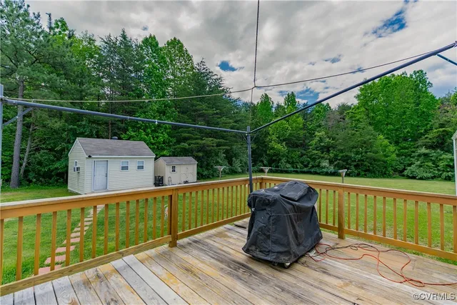 a view of balcony with wooden floor and outdoor seating
