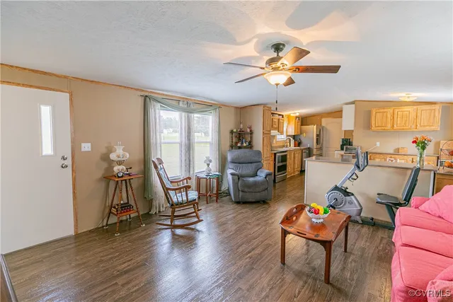 a living room with furniture a fireplace and wooden floor