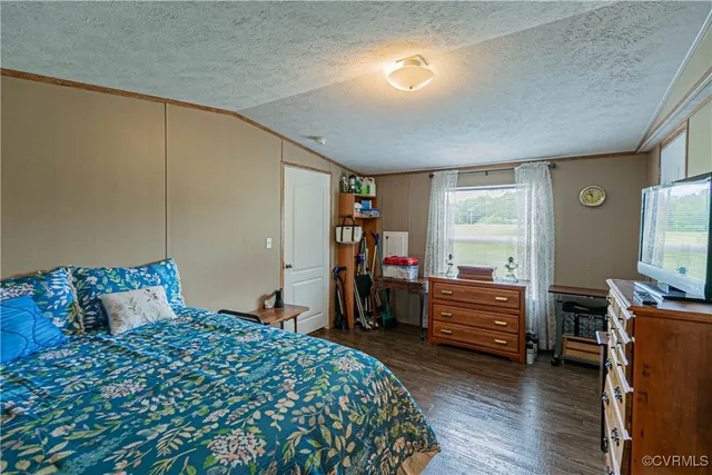 a kitchen with stainless steel appliances a stove a sink a refrigerator white cabinets and wooden floor