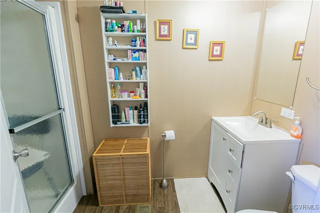 a bathroom with a glass shower door and mirror