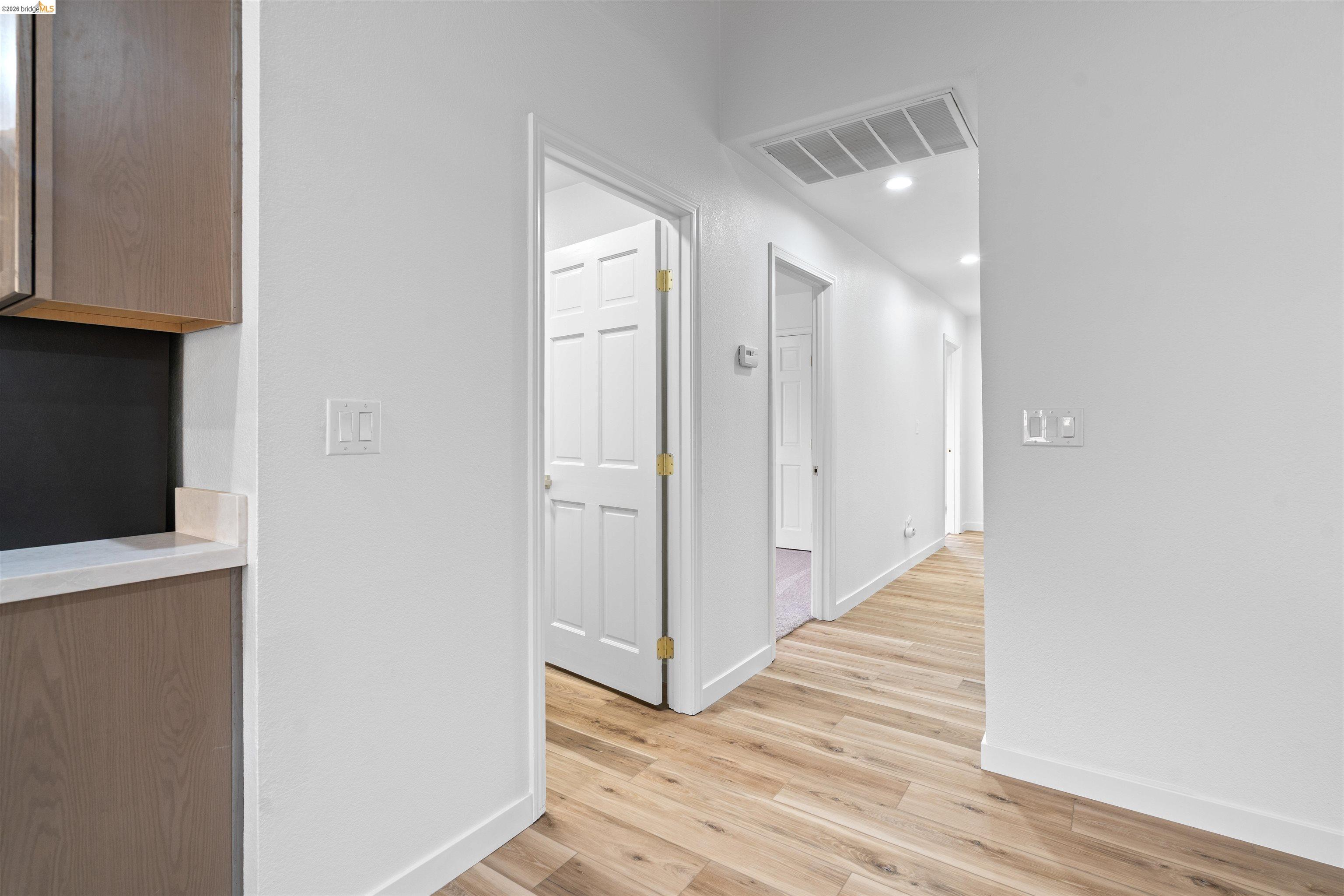 19676 Rawhide Road Sonora, CA 95370 - Photo 20 of 67 Wood-finish flooring throughout, white walls, recessed lighting, and white paneled doors