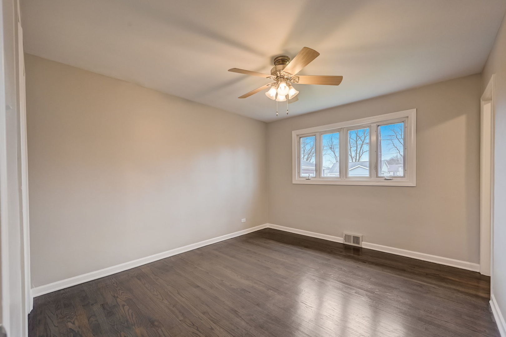 3132 Willow Road South Chicago Heights, IL 60411 - Photo 11 of 26 a view of empty room with wooden floor and fan
