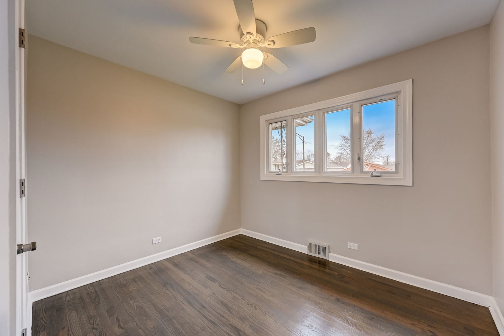 3132 Willow Road South Chicago Heights, IL 60411 - Photo 13 of 26 an empty room with wooden floor and windows