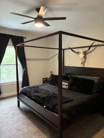 a bedroom with a bed and a window