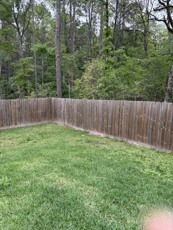 a view of a backyard with a wooden fence