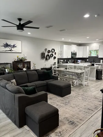 a living room with lots of furniture and kitchen view