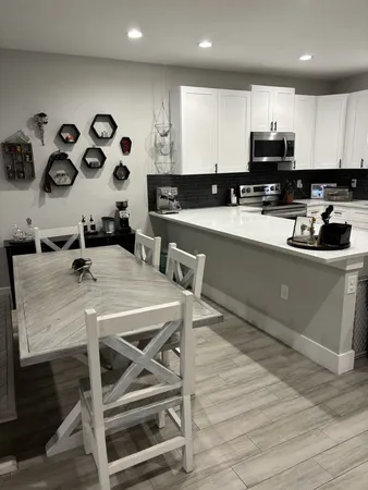 a kitchen with a table and chairs in it