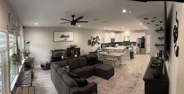 a living room with furniture and a flat screen tv