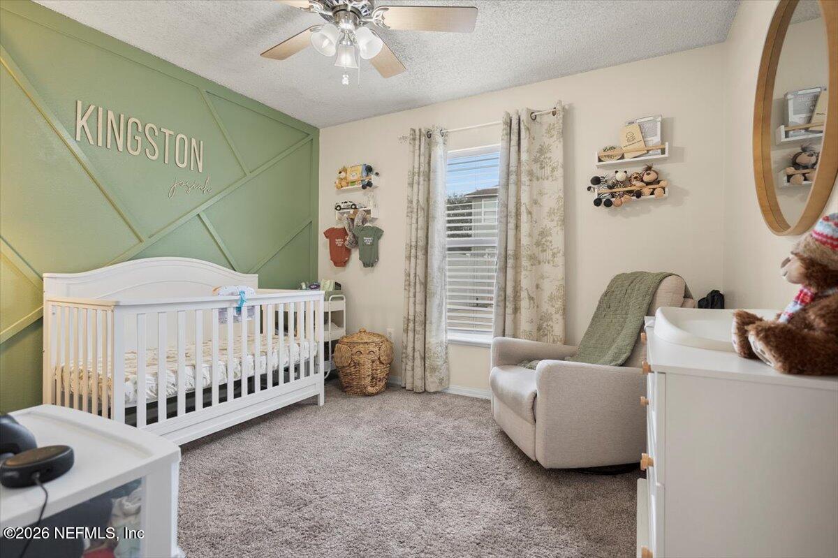 10310 Woodley Point Road Jacksonville, FL 32218 - Photo 11 of 30 a bedroom with furniture and a window