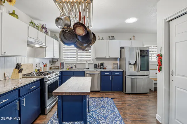 a kitchen with a refrigerator a stove top oven a sink and dishwasher