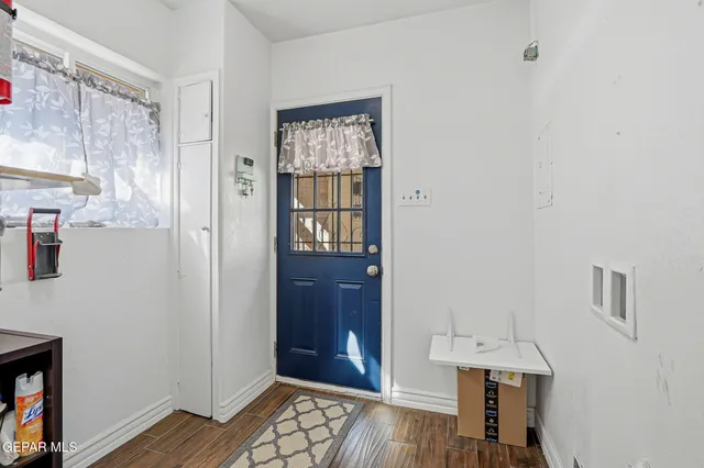 a view of an entryway with wooden floor