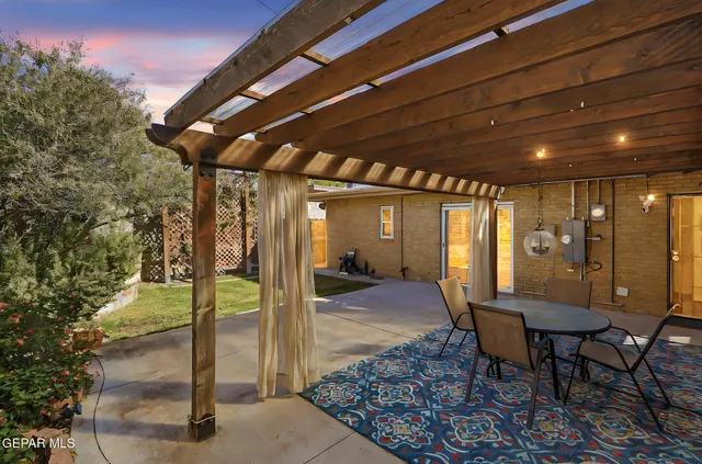 a view of a porch with furniture and a yard