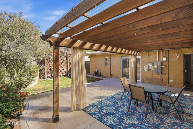 a view of a porch with furniture and a yard
