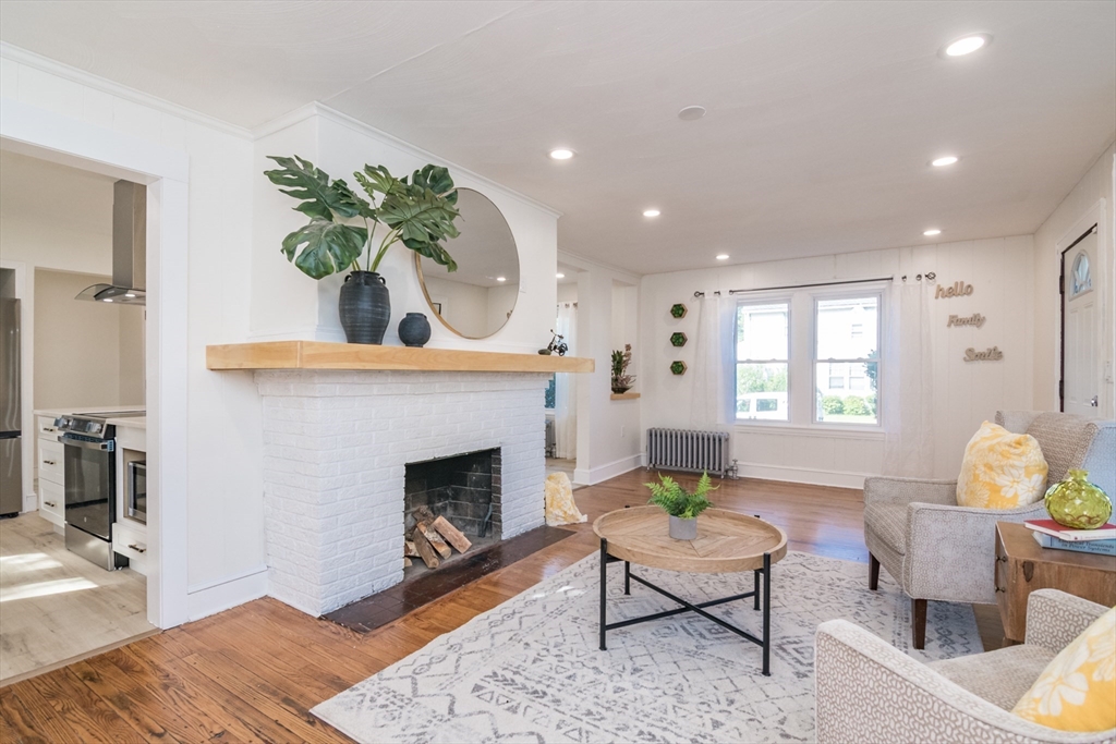 1235 Bay Street Springfield, MA 01109 - Photo 14 of 35 a living room with furniture a fireplace and a table