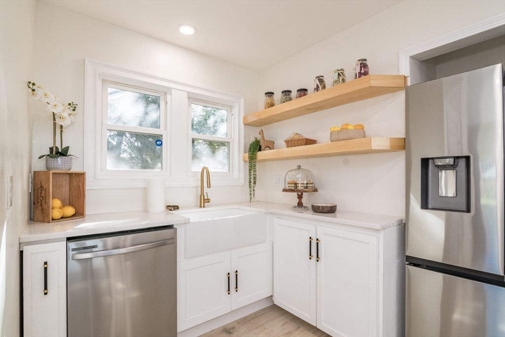 1235 Bay Street Springfield, MA 01109 - Photo 18 of 35 a kitchen with a sink a refrigerator and window
