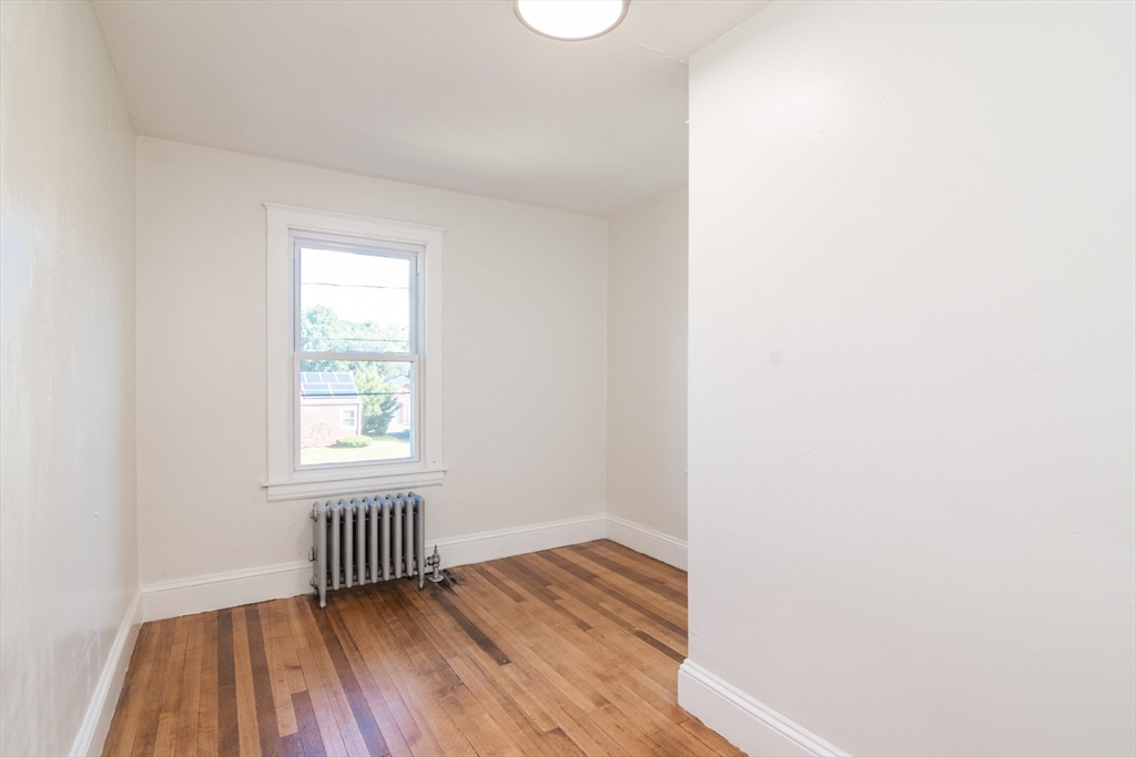 1235 Bay Street Springfield, MA 01109 - Photo 25 of 35 a view of an empty room with wooden floor and a window
