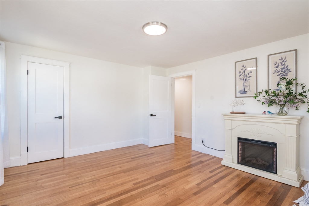 1235 Bay Street Springfield, MA 01109 - Photo 26 of 35 a view of an empty room with wooden floor and a fireplace