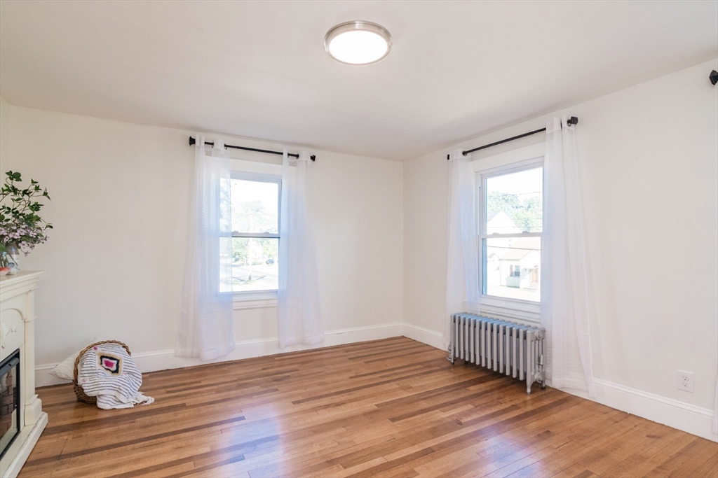 1235 Bay Street Springfield, MA 01109 - Photo 27 of 35 a view of an empty room with wooden floor and a window