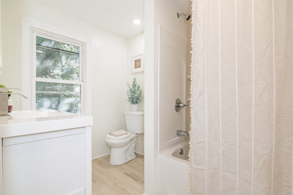 1235 Bay Street Springfield, MA 01109 - Photo 31 of 35 a bathroom with a shower a toilet and a window