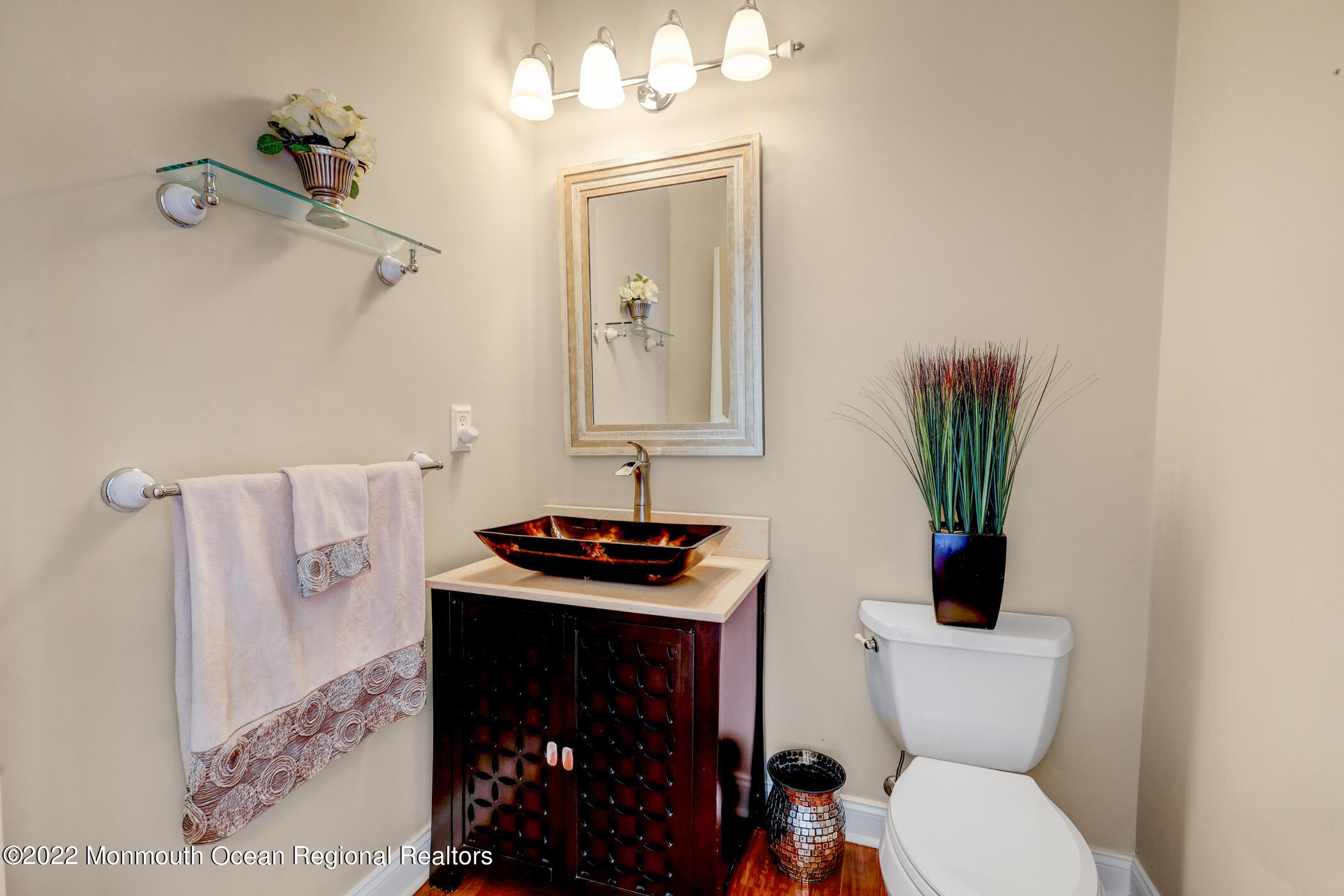 19 Rockingham Court Manalapan, NJ 07726 - Photo 27 of 52 a bathroom with a toilet a sink and mirror
