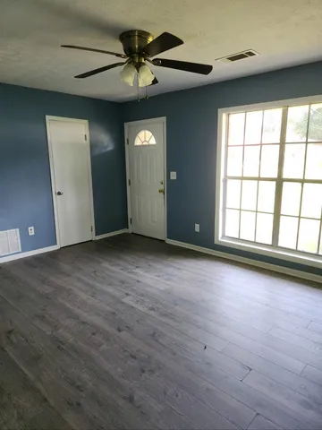 a kitchen with granite countertop a refrigerator stove and cabinets