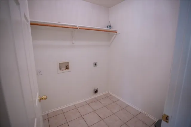 an empty room with wooden floor chandelier fan and windows