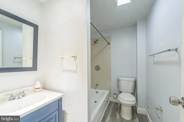 a white toilet sitting next to a bathroom sink
