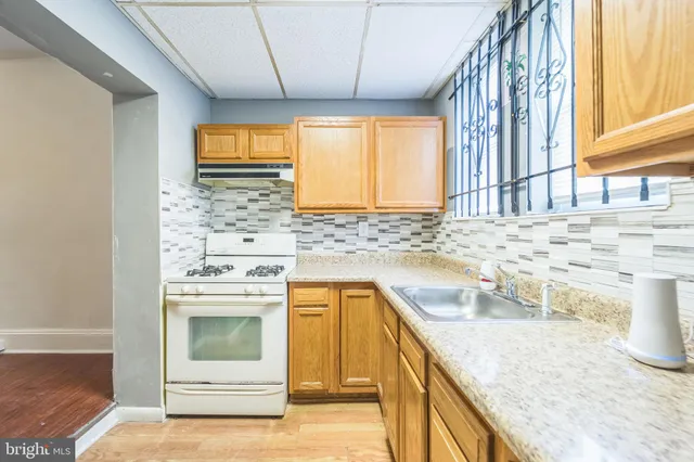 a kitchen with a sink stove and cabinets