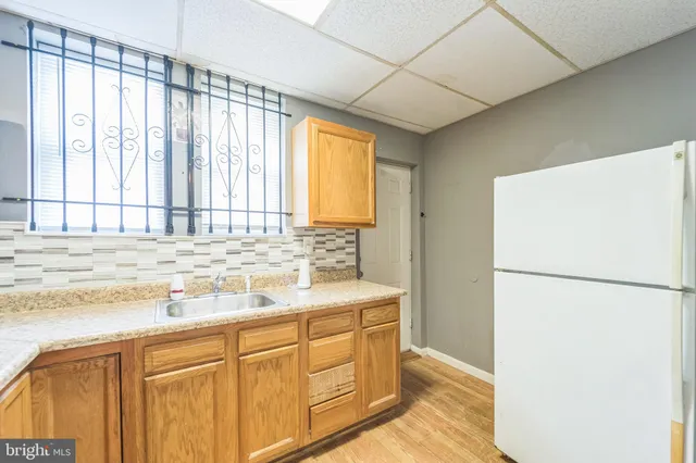 a kitchen with stainless steel appliances granite countertop a refrigerator sink and cabinets