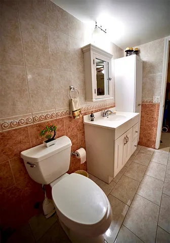 a bathroom with a toilet a sink and mirror