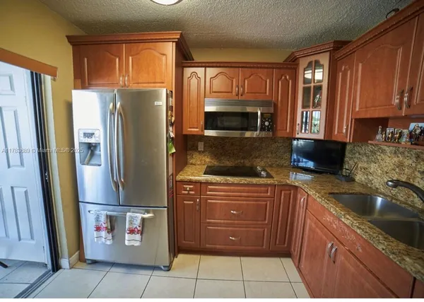 a kitchen with a refrigerator sink and microwave