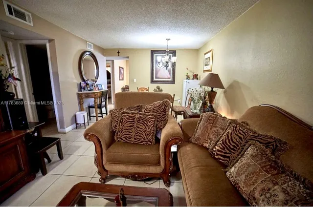 a living room with furniture a flat screen tv and a large window