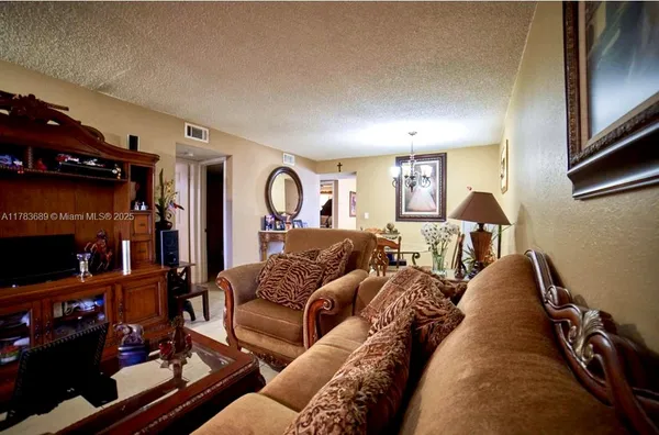 a living room with furniture and a lamp