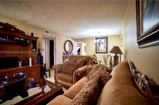 a living room with furniture and a lamp