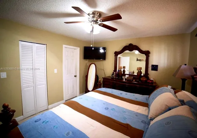 a bed room with a bed mirror and a window