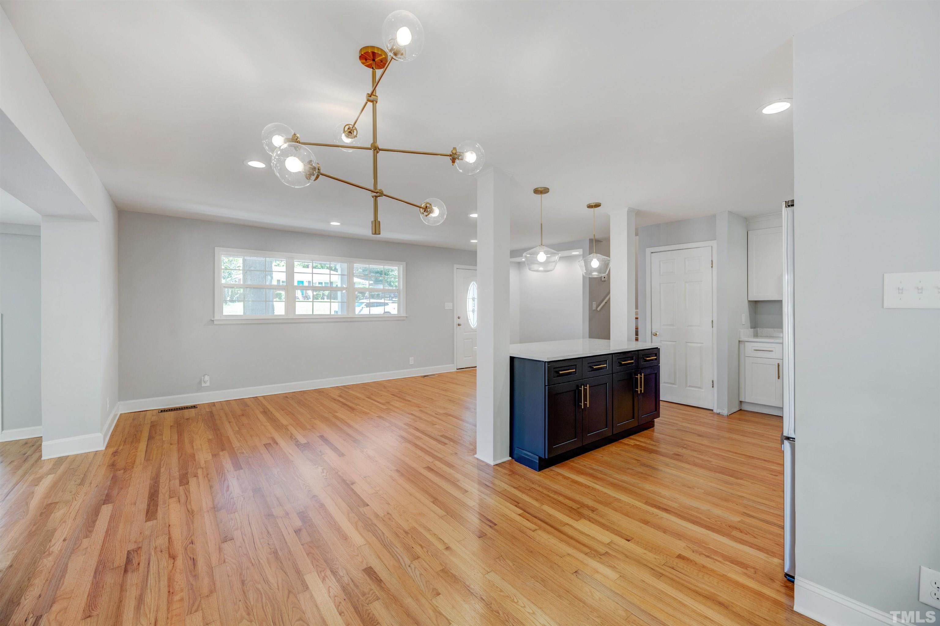 618 Starmont Drive Durham, NC 27705 - Photo 12 of 45 a view of an empty room and kitchen with wooden floor