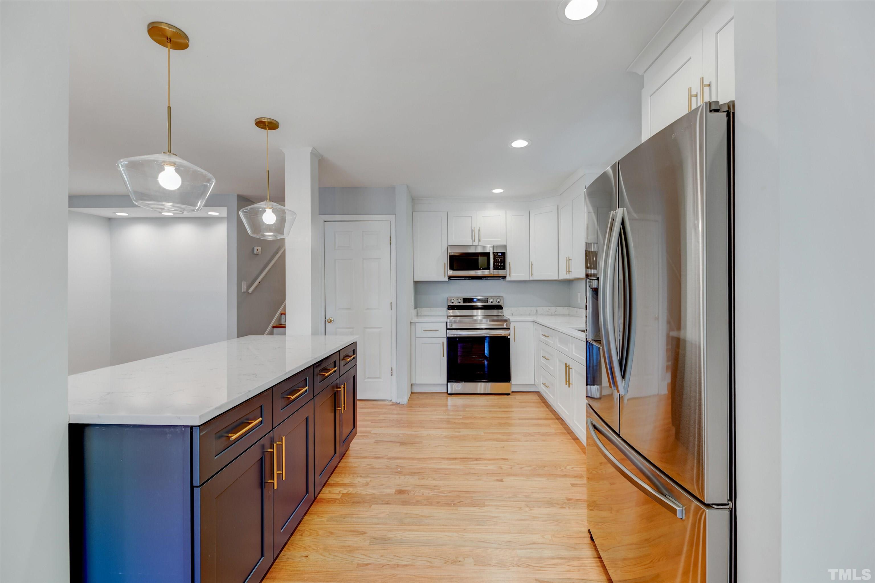 618 Starmont Drive Durham, NC 27705 - Photo 13 of 45 a kitchen with stainless steel appliances a refrigerator sink and cabinets
