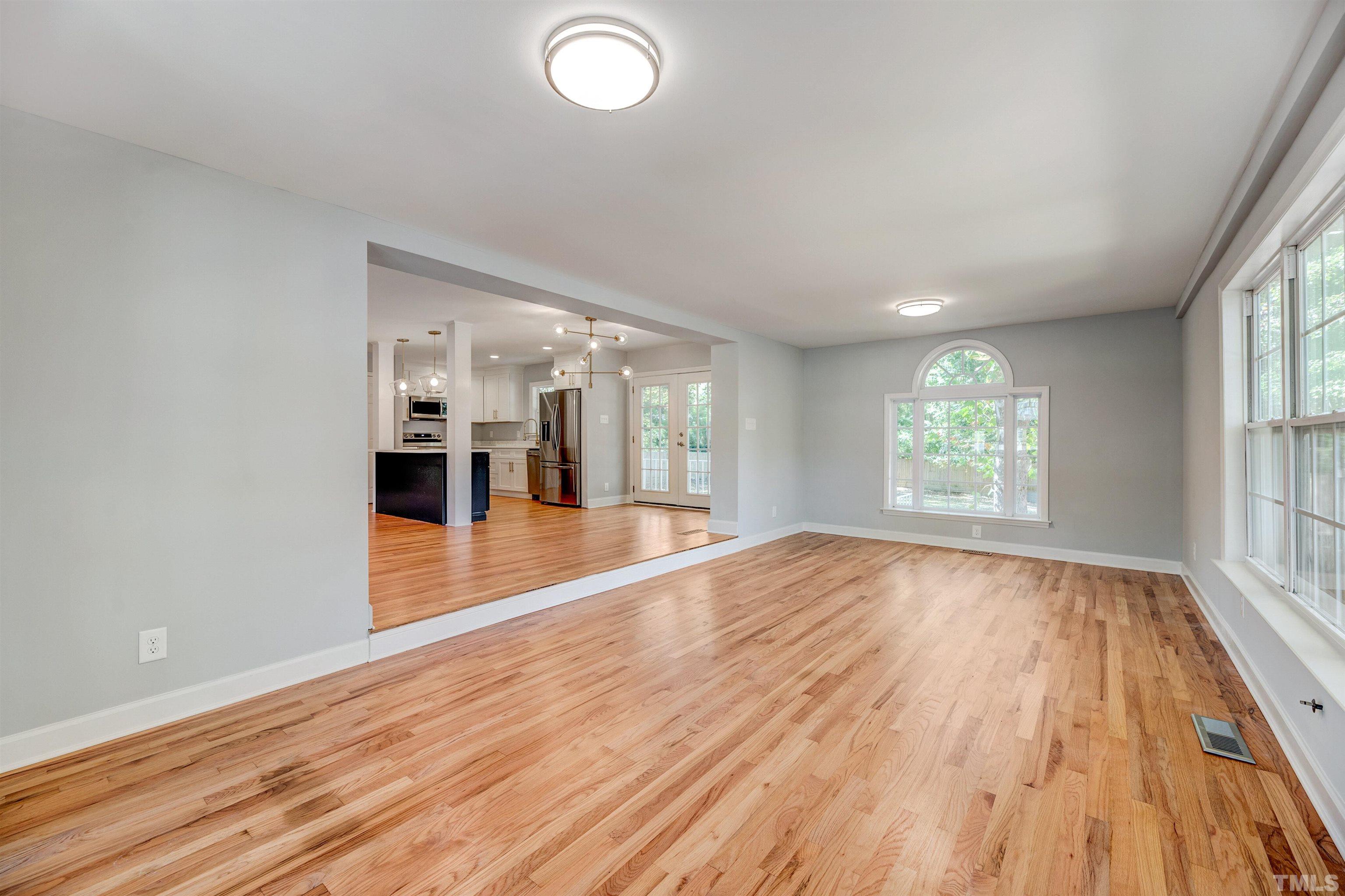618 Starmont Drive Durham, NC 27705 - Photo 21 of 45 an empty room with wooden floor and windows