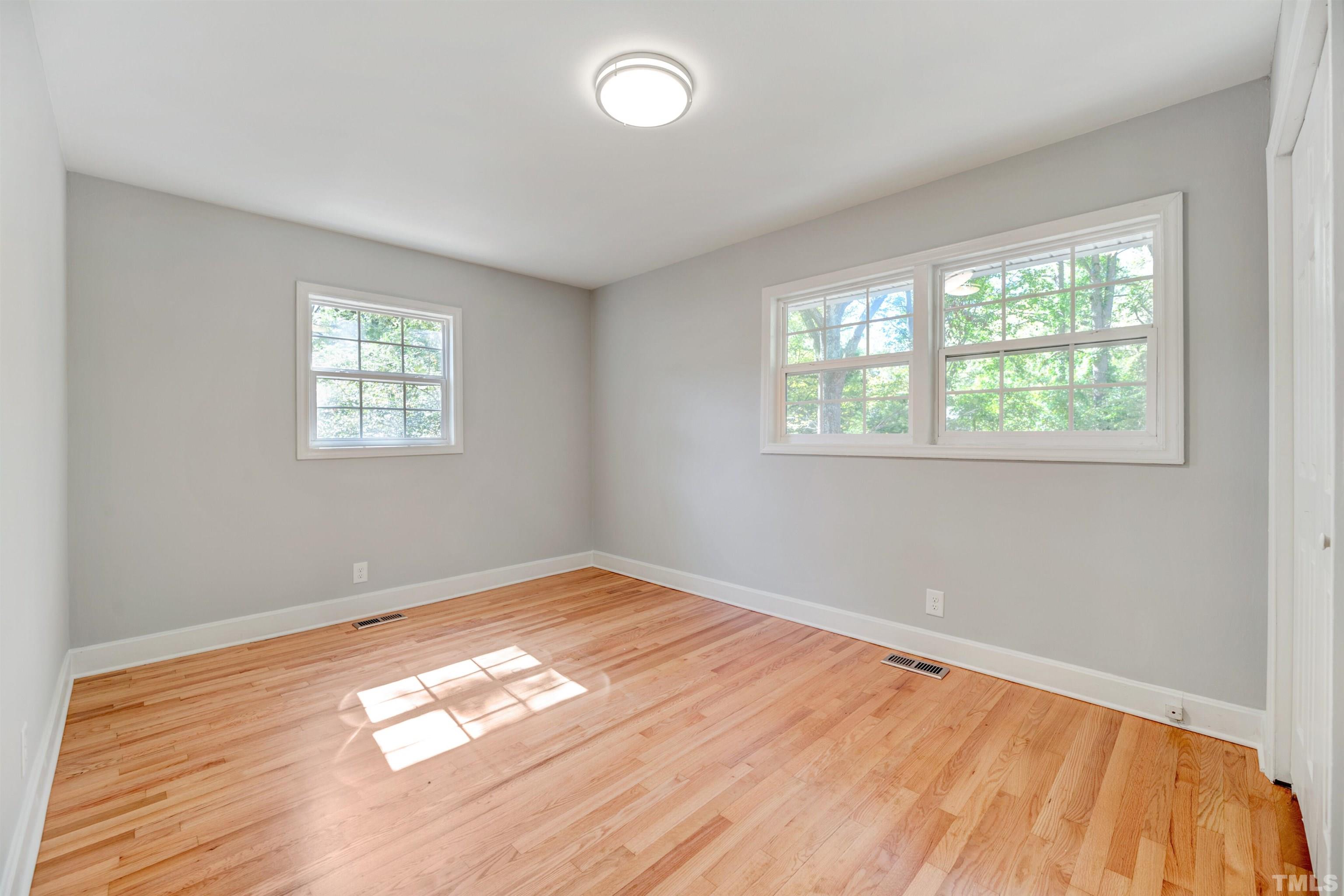 618 Starmont Drive Durham, NC 27705 - Photo 22 of 45 a view of empty room with wooden floor and fan