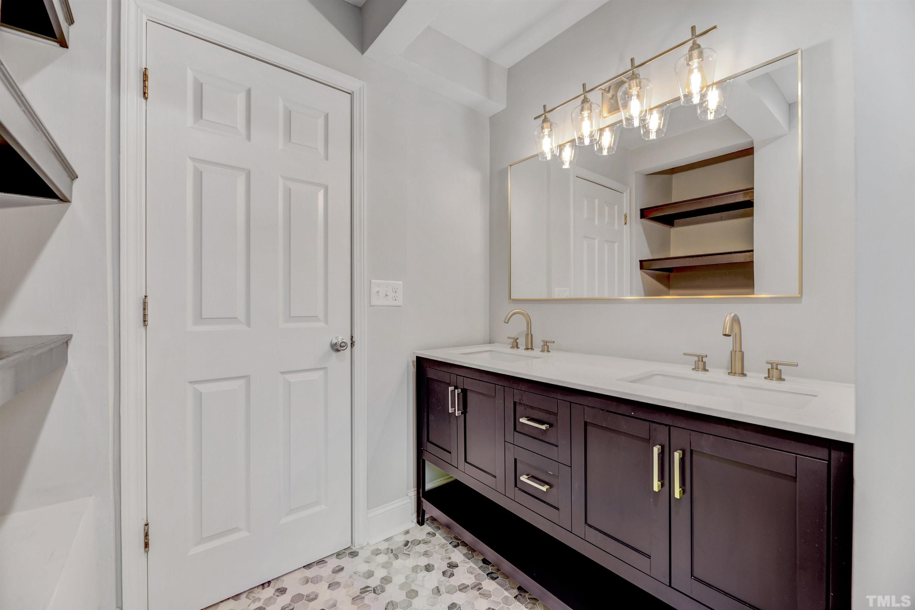 618 Starmont Drive Durham, NC 27705 - Photo 29 of 45 a bathroom with a double vanity sink and a mirror