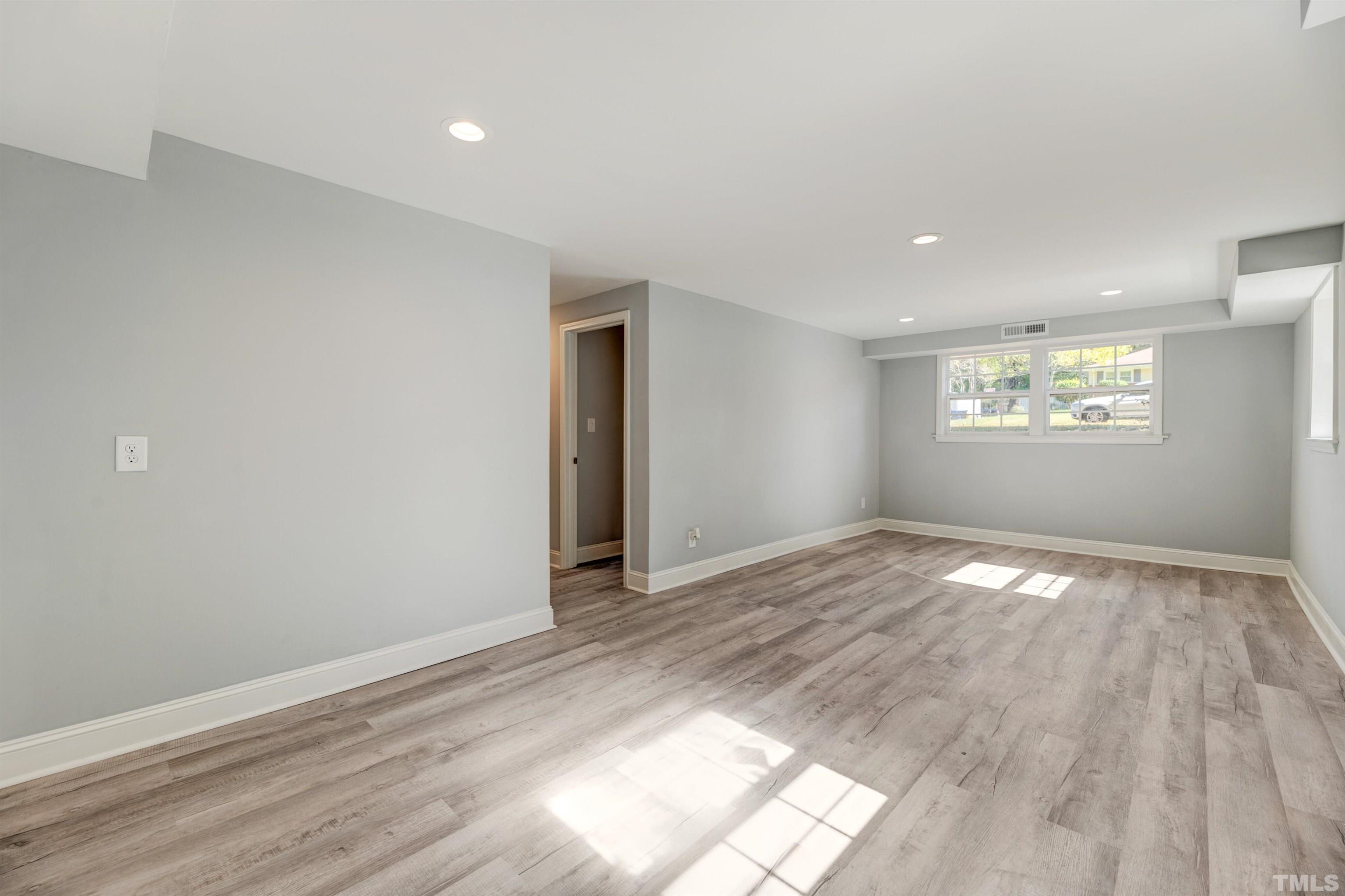 618 Starmont Drive Durham, NC 27705 - Photo 31 of 45 a view of empty room with wooden floor and fan