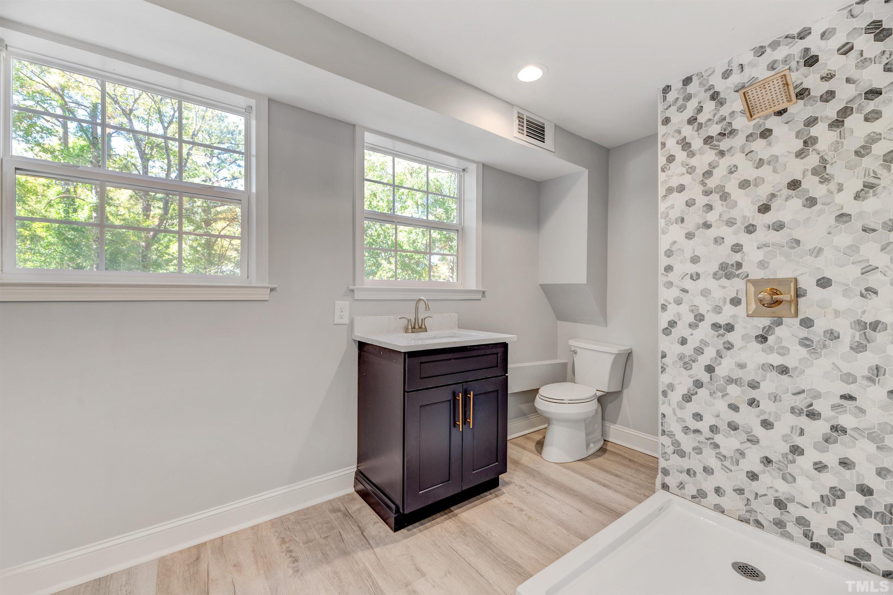 618 Starmont Drive Durham, NC 27705 - Photo 34 of 45 a bathroom with a sink a toilet and a window