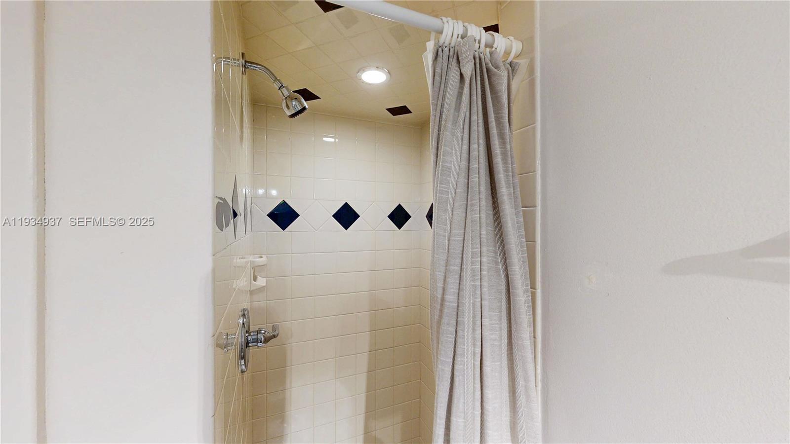 13292 Southwest 114th Terrace Miami, FL 33186 - Photo 18 of 65 a bathroom with a glass shower door and a glass door