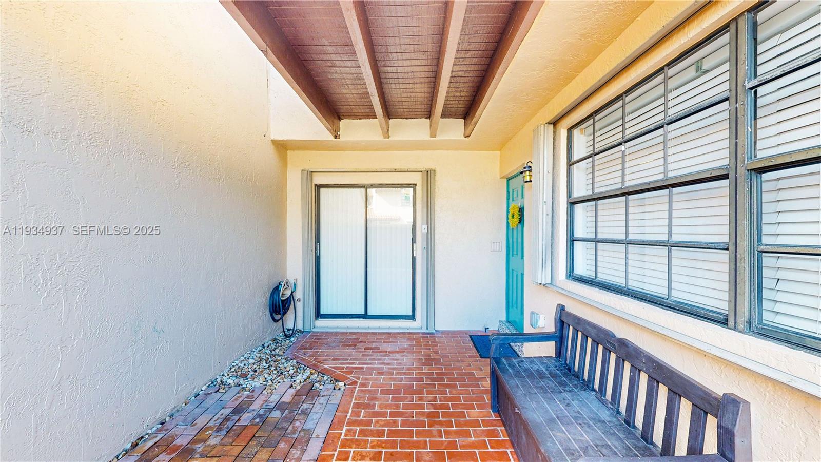 13292 Southwest 114th Terrace Miami, FL 33186 - Photo 4 of 65 a view of a hallway with wooden floor and windows